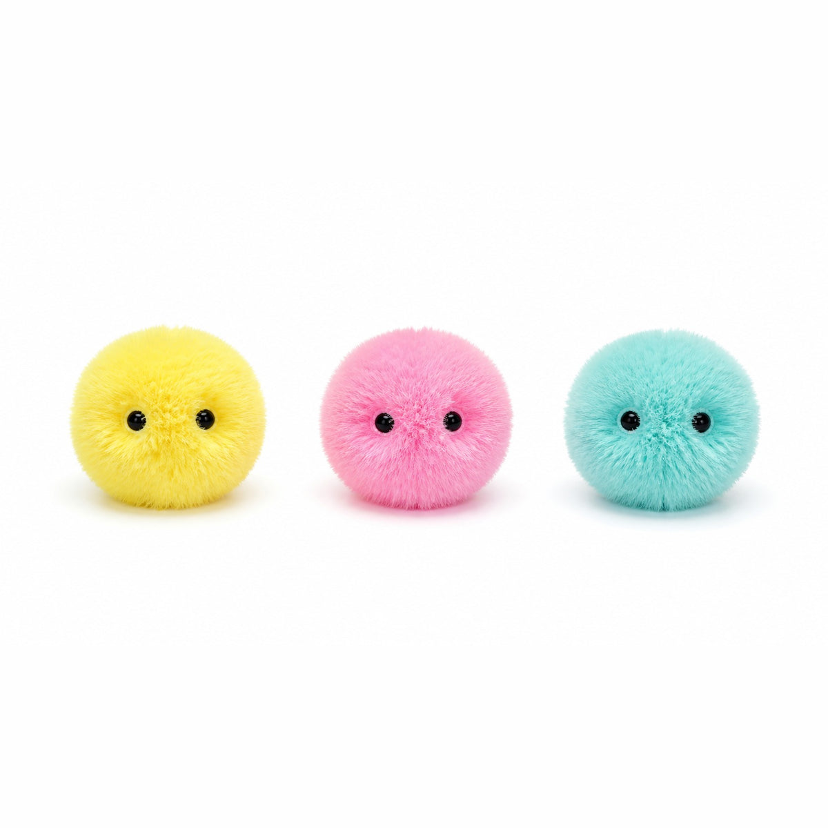 Les trois coloris de la balle interactive : jaune, rose et turquoise